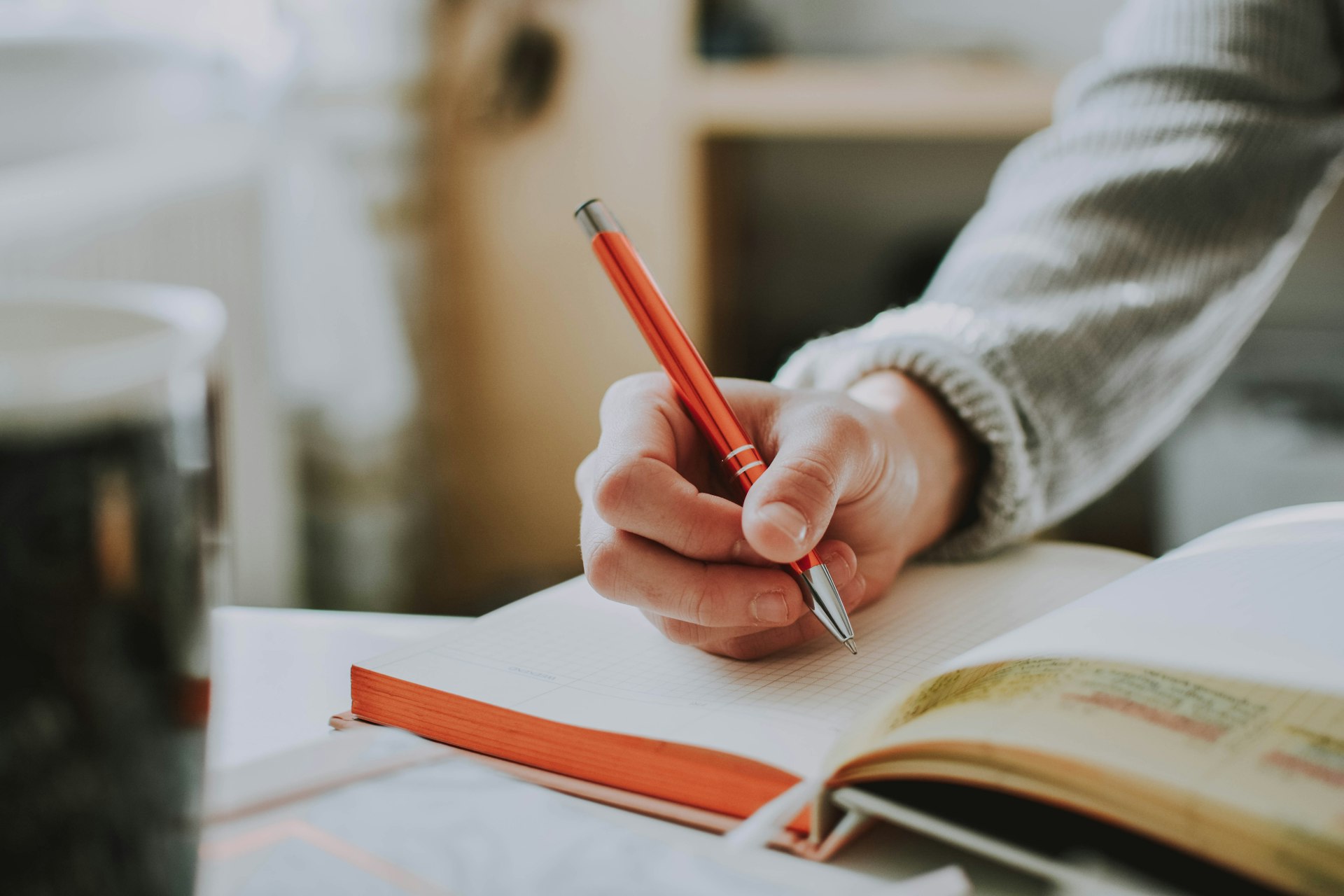 Person writing health goals in a notebook